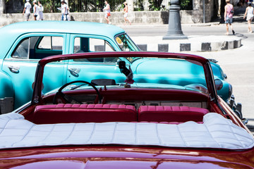 Old colorful vintage classic car on the streets of Havanas Old Town. American Chevrolet cars used for transportation and tourism services. Cuban revolution and tradition.