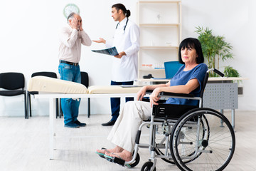 Old couple visiting young male doctor