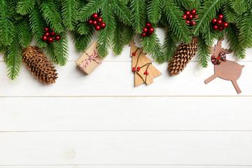 Fototapeta na wymiar Top view of fir tree and New Year decorations on wooden background. Christmas concept with copy space