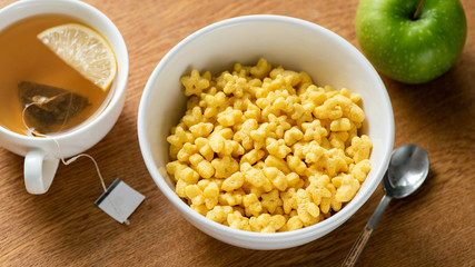 Breakfast Corn Cereals And Cup Of Green Tea On Wooden Table