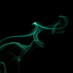 Beautiful swirls of green smoke on a black background