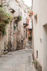 Fototapeta na wymiar selective focus of narrow street in ragusa, italy