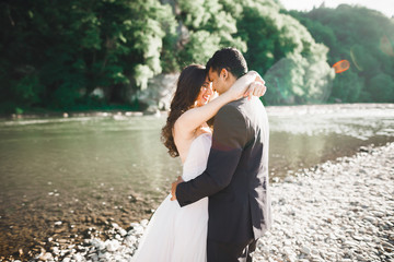 Gorgeous happy couple standing close to each other and looking in eyes