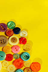 Abstract colorful background. Multi-colored buttons over yellow background, copy space for text. 