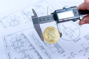 Bitcoin price in vernier caliper. Using a caliper to measure the price of bitcoin against a...