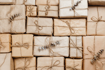 Various gift boxes wrapped in eco-friendly craft paper with strings