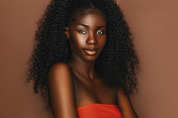 Fototapeta African beautiful woman portrait. Brunette curly haired young model with dark skin and perfect smile obraz