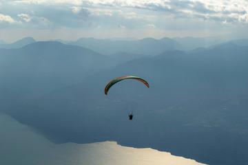 Paragliders flying in mount Baldo, lake Garda, Italy