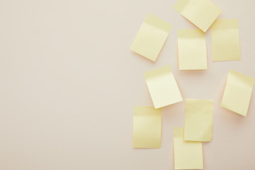top view of blank sticky notes isolated on beige