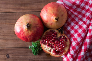 natural pomegranate on rustic wooden background