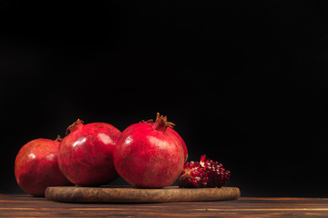 Ripe pomegranate fruit on wooden vintage background. - Image