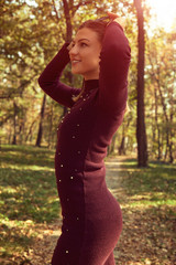 Portrait of beautiful elegant woman enjoying and posing in autumn day.