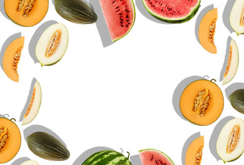 Sweet melons of different varieties and watermelon, whole, halves and slices, isolated on white with copy space for text, images. Close-up, top view.