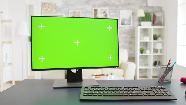 Display with green screen in cozy and well lit living room