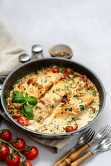 Delicious tuscan cream salmon with spinach in a black pan