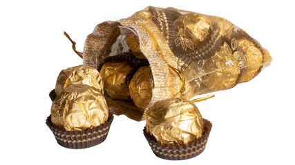 Candy in gold wrappers, isolated on white background