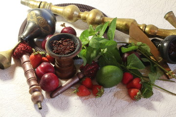 bowl with tobacco for hookah. fruits on a dark background. smoking nargile