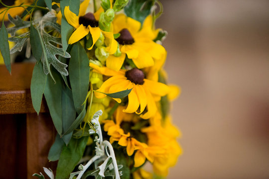 Yellow Wedding Flowers On A Church Pew