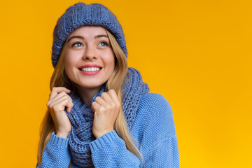 Portrait of beautiful girl in blue knitted winter set