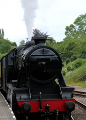 Fototapeta na wymiar A Powerful Vintage Black Steam Railway Engine.