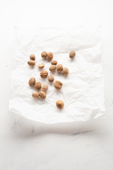 Whole organic nutmegs on paper