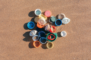 Plastic plugs collected on the beach. Ocean plastic pollution concept.