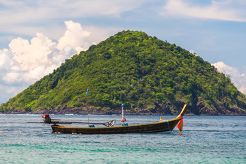 Fototapeta na wymiar Boat on the background of the Andaman Sea island
