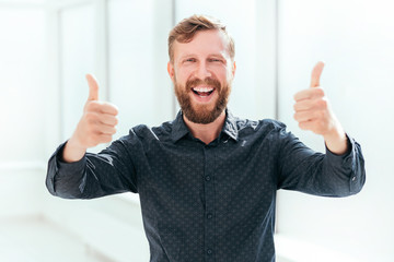 happy businessman showing thumbs up. photo with copy space