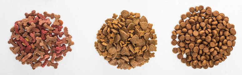 top view of assorted dry pet food in piles isolated on white, panoramic shot