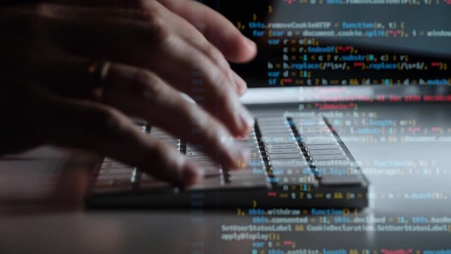Cinematic close up of hands typing code on a keyboard with Multiple layers of codes and programmer shown beneath them. Hacking programming concept.