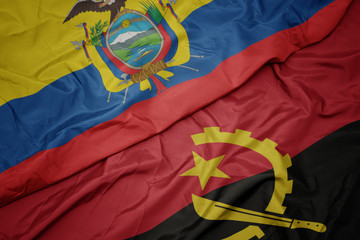 waving colorful flag of angola and national flag of ecuador.