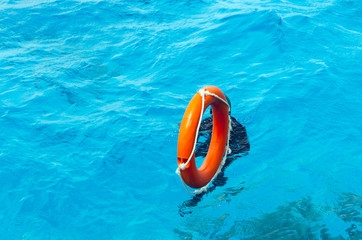 A lifebuoy is thrown into the water of a drowning person