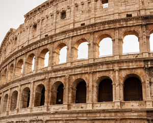 Rome Italy. Exterior of the Colosseum, famous for shows with gladiators in the Roman Empire, inserted in the new seven wonders of the world. Detail of the typical architectural arches and friezes.