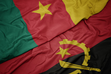 waving colorful flag of angola and national flag of cameroon.