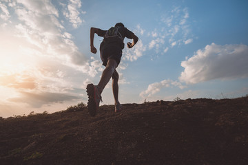 Runners running fitness in woods.athlete running on trail stones.