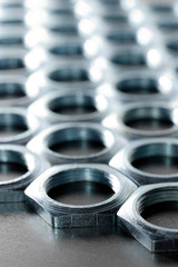 Close-up chrome metal nuts. Metal lines