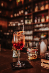 A glass of Aperol cocktail on a bar. Concept of summer drinks and hospitality. Classic summer drink from Northern Italy.