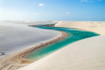Papier Peint photo Brésil A beautiful turquoise river flowing through white dunes in Brazil