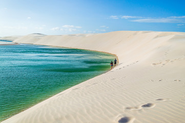 A couple walking on white sand oasis in Brazil