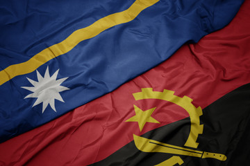 waving colorful flag of angola and national flag of Nauru .