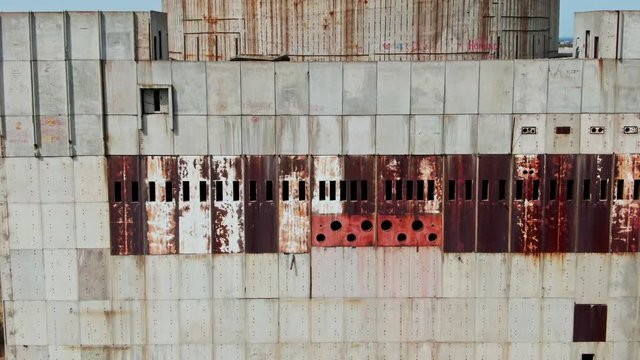 AERIAL SHOT Post Apocalyptic background from ferroconcrete wall Row of panels with rusty spots With around hat on the top