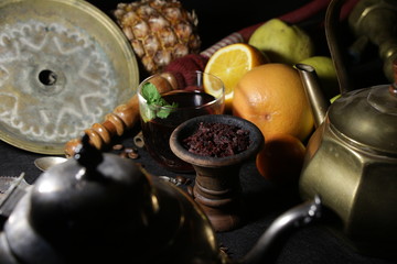 bowl with tobacco for hookah. passion fruit on a dark background. smoking hookah