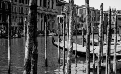 Gondolas docked in canal on island of Venice Italy