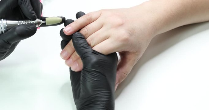 Procedure of hardware manicure in a beauty salon for women