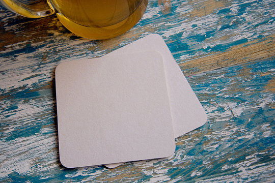 empty blank cardboard beermat on wood mockup