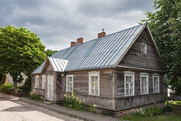 Fototapeta na wymiar Trakai, Lithuania - View of Karaites street with traditional wooden, colored, three window houses
