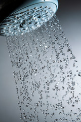 Shower head and water drops in frozen motion.