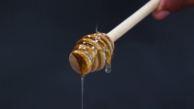 Honey is nutritious for health, stirring with a honey spoon and honeycomb