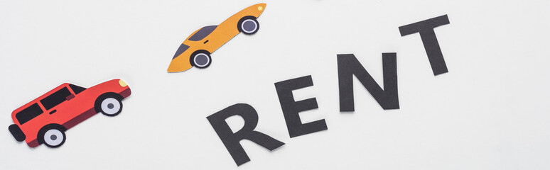 top view of paper cut vehicles and black rent lettering on white background, panoramic shot