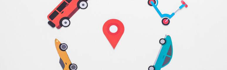 top view of paper cut vehicles arranged in round frame on white background with location mark, panoramic shot